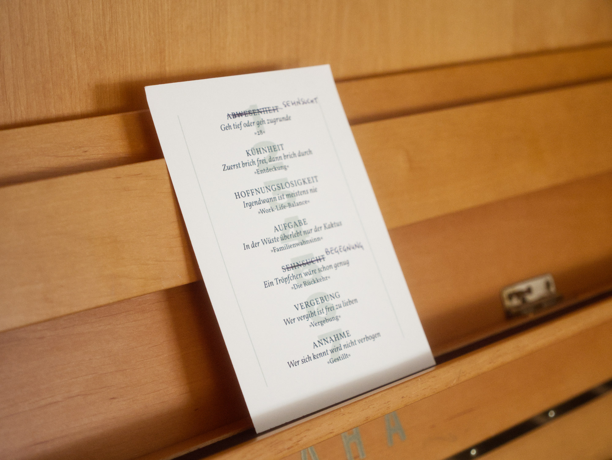 A song list, a programm for a concert placed on a piano note stand.